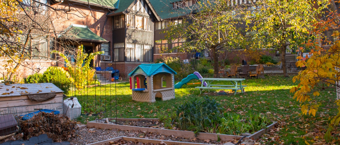 Exterior of Bain Apartments housing co-operative showing a garden and a play structure