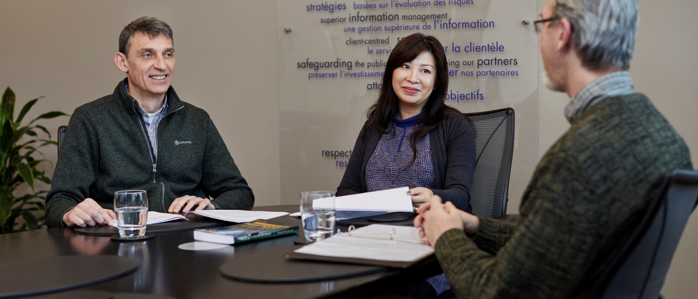 Three co-workers in a meeting at the Agency