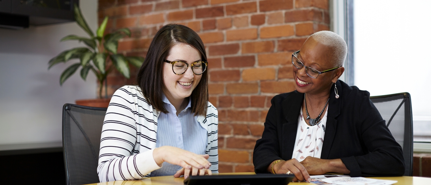 Two Agency co-workers in conversation