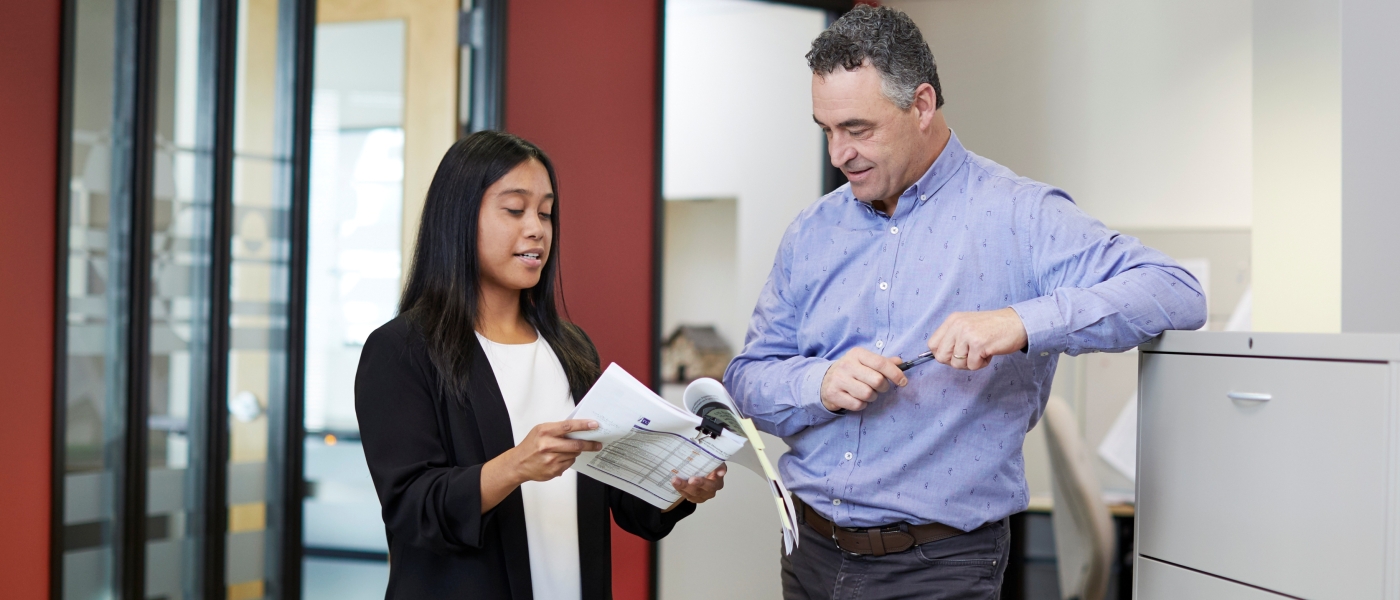 Two Agency co-workers having a conversation about a document