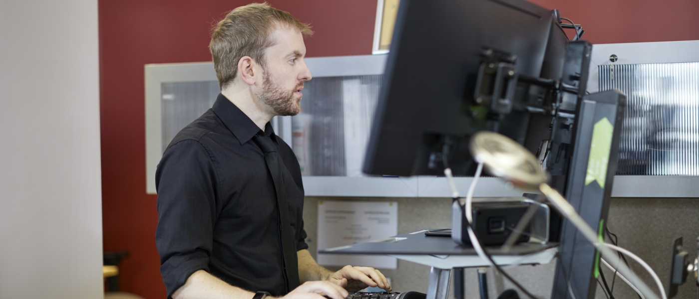 Colin MacDougall working at a standing desk