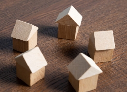 A ring of small wooden houses on table