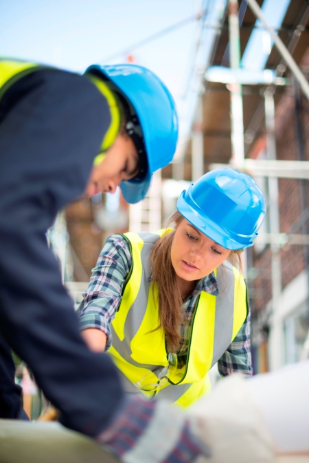 Two workers on a construction site having a discussion